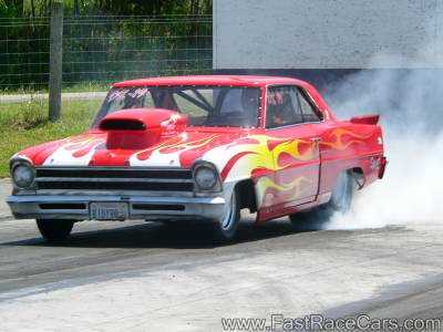 Red 1967 NOVA Drag Car Doing Burnout